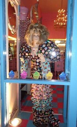 In the front window of Philly Cupcake stands this mannequin dressed in a cupcake decorated outfit.