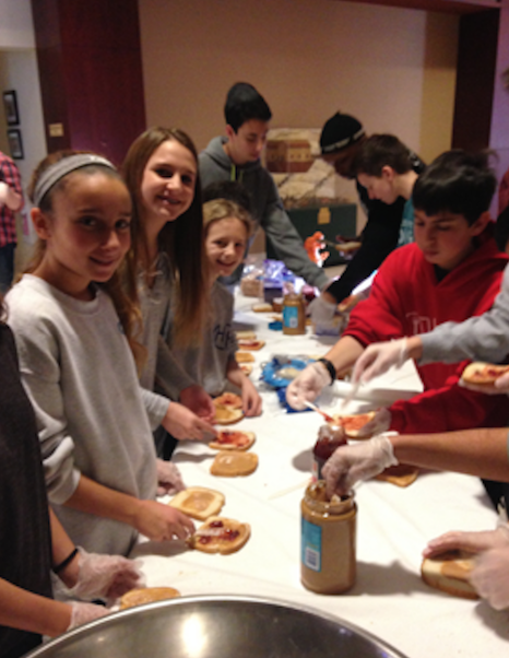 Volunteers from Congregation Beth El make food for those in need. 