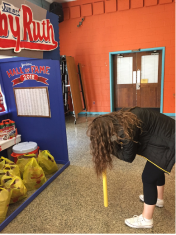 The juniors put a spin on the game, Dizzy Bat, by having students attempt to throw a baseball into a gatorade bottle.