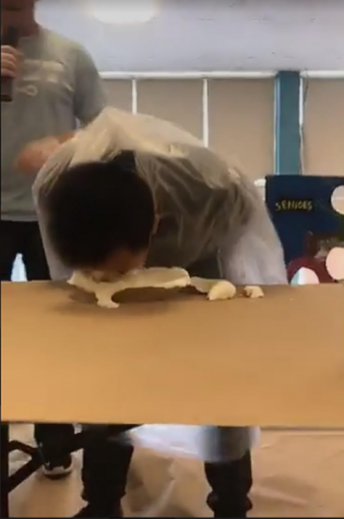 Sophomore Calvin Chan ('19) stuffs his face with pie, as he searches for the candy hidden within it. 